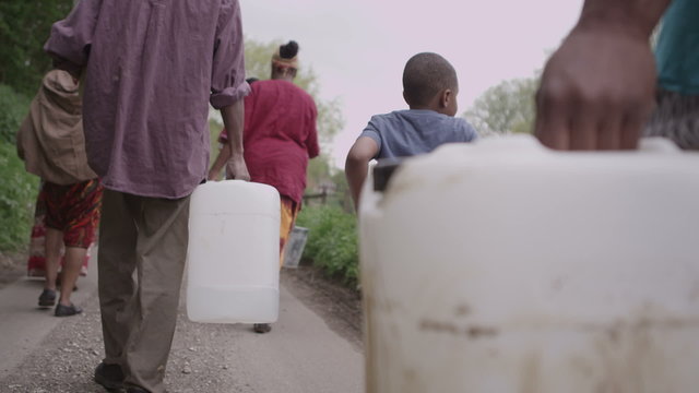 African villagers travel together to find water