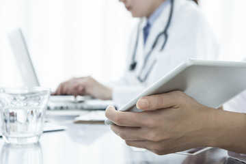 Physician is showing an electronic tablet