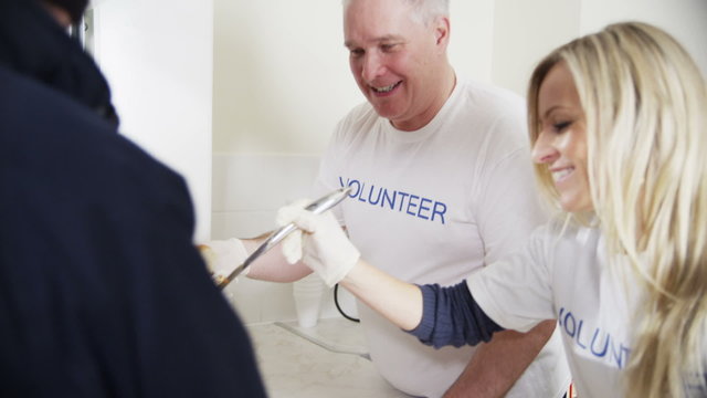 Soup kitchen volunteers help to feed the homeless