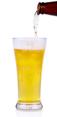 Beer into glass isolated on white background