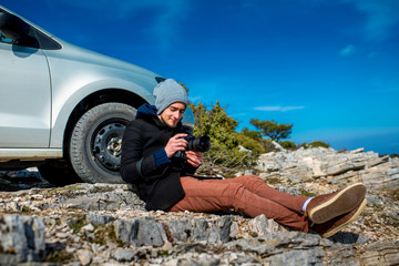 Photographer with car on the top of mountain
