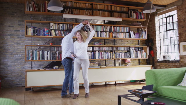 Romantic couple dancing together in the living room