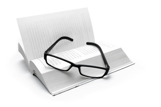 book and glasses isolated on white