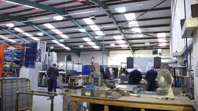 Time lapse of a busy team of manual workers operating machinery