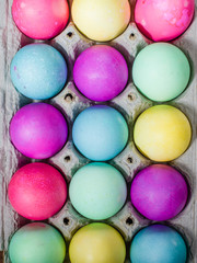 Egg carton of colorful dyed Easter eggs