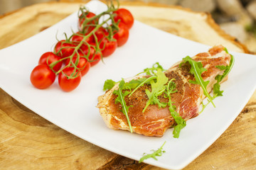 piece of meat, tomatoes and greens