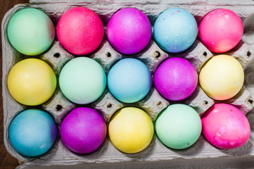 Egg carton of colorful dyed Easter eggs