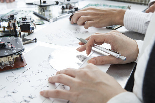 People who are designing the car parts