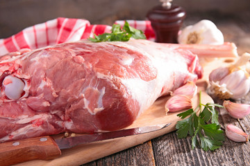 raw lamb leg on board