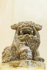 the ancient chinese lion statue under the sun light