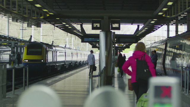 Travelers and commuters on the platform at St. Pancras railway station, London