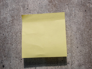 yellow reminder sticky note on wall