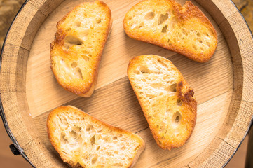 Grilled slices of bread for a snack on the barrel