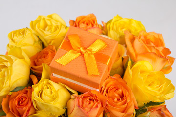 little gift box in beautiful bouquet of roses