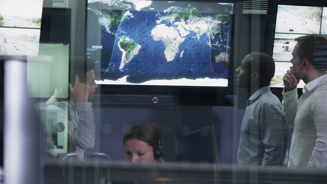 Security team watching the screens in control center office