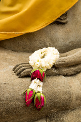 Garland on a hand of Buddha statue