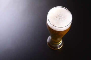 Tall glass of light beer