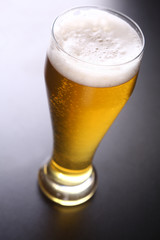 Tall glass of light beer