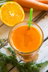 Orange-Karotten-Smoothie im Glas auf Holz
