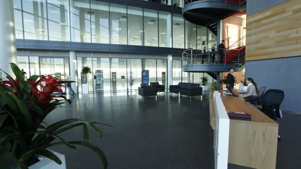 Time lapse of large business group in a light and modern office building