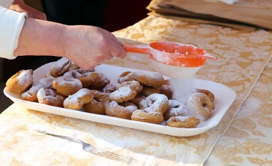 Elder Cook spread the icing sugar over cooked fritters