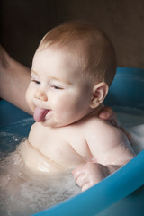 sticking out tongue baby washing