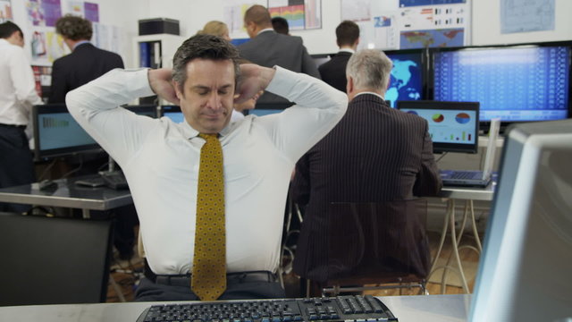 Bored and sleepy businessman struggles to stay awake at work