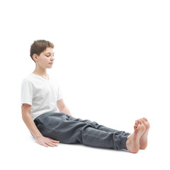 Young boy stretching or doing yoga