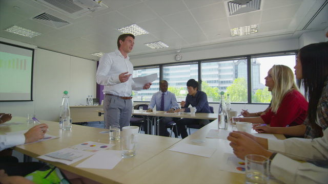 Mixed ethnicity business team in boardroom meeting or training seminar