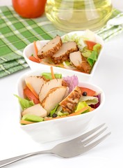 A fresh chicken salad in a heart shaped bowl