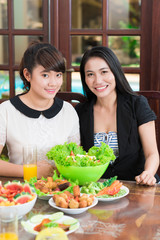 Asian mother and daughter at the table