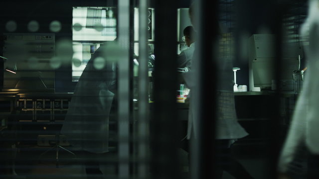 Multi ethnic scientific research team working in the lab