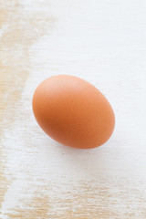 Healthy food brown chicken egg on white wood table background