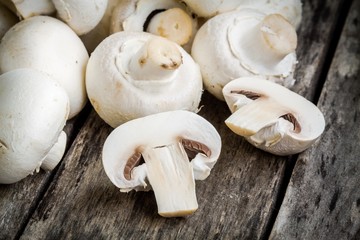 raw champignons on a rustic table close up