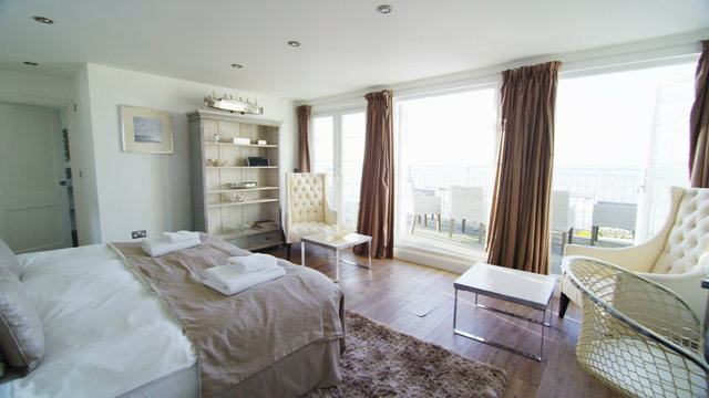 Interior view of bedroom in a stylish beachside home. No people.