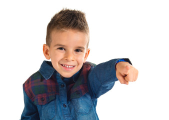 Kid pointing to the front over white background