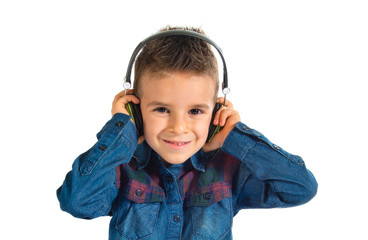 Kid listening music over white background