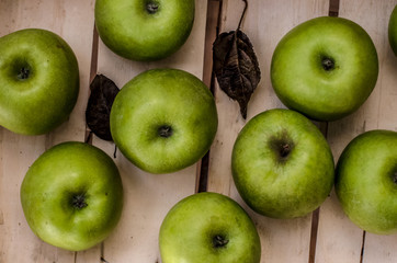 Green apples on the bottom of crate