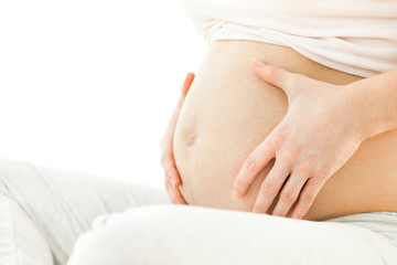 Pregnant woman holding stomach