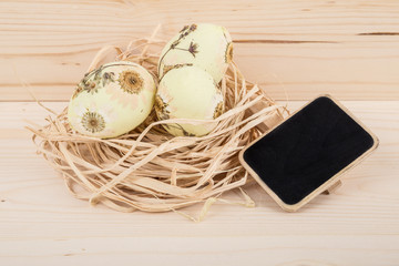 easter eggs decorated with flowers and blackboard