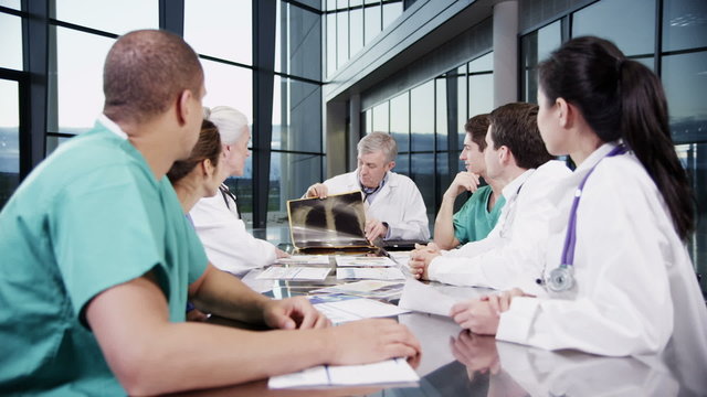 Multi ethnic medical team in a meeting discuss a patient's x-ray results