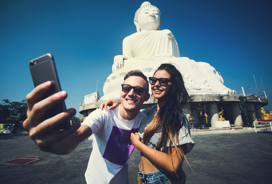 Multiracial couple of students make selfie traveling in Asia