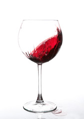 red wine swirling in a goblet wine glass,