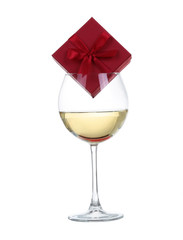 Glass of wine with gift box isolated on white