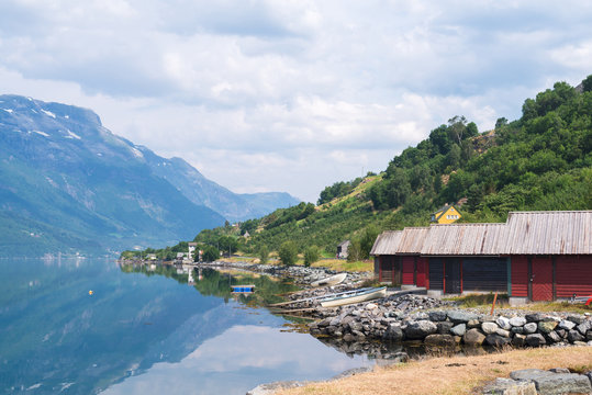 Red boat-houses at th shore of fjord