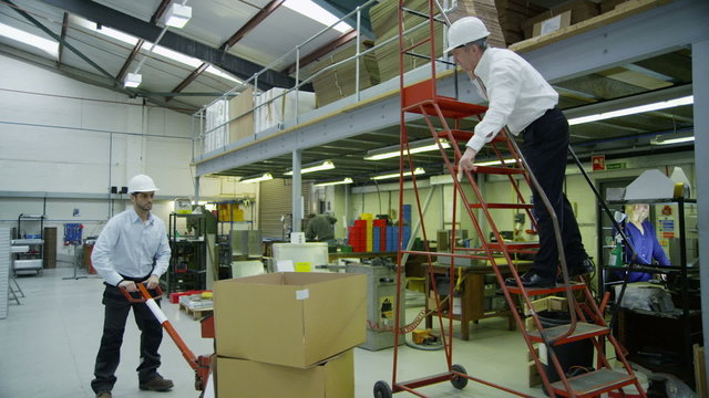 Staff members in a busy warehouse, each carrying out their own roles