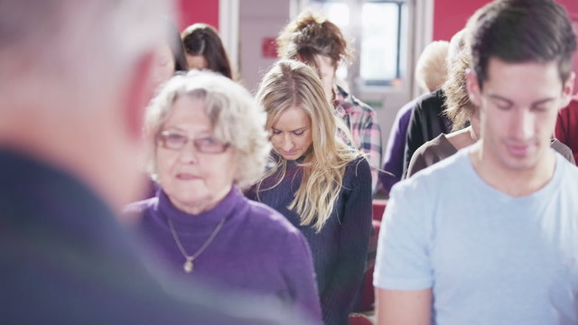 Church group bow their heads to pray