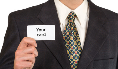 Man's hand is showing blank business card. He is in black suit,