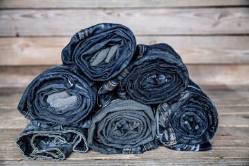Clothing. twisted jeans on a wooden background