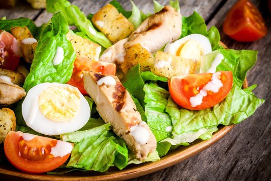 Caesar salad with croutons, cherry tomatoes and grilled chicken